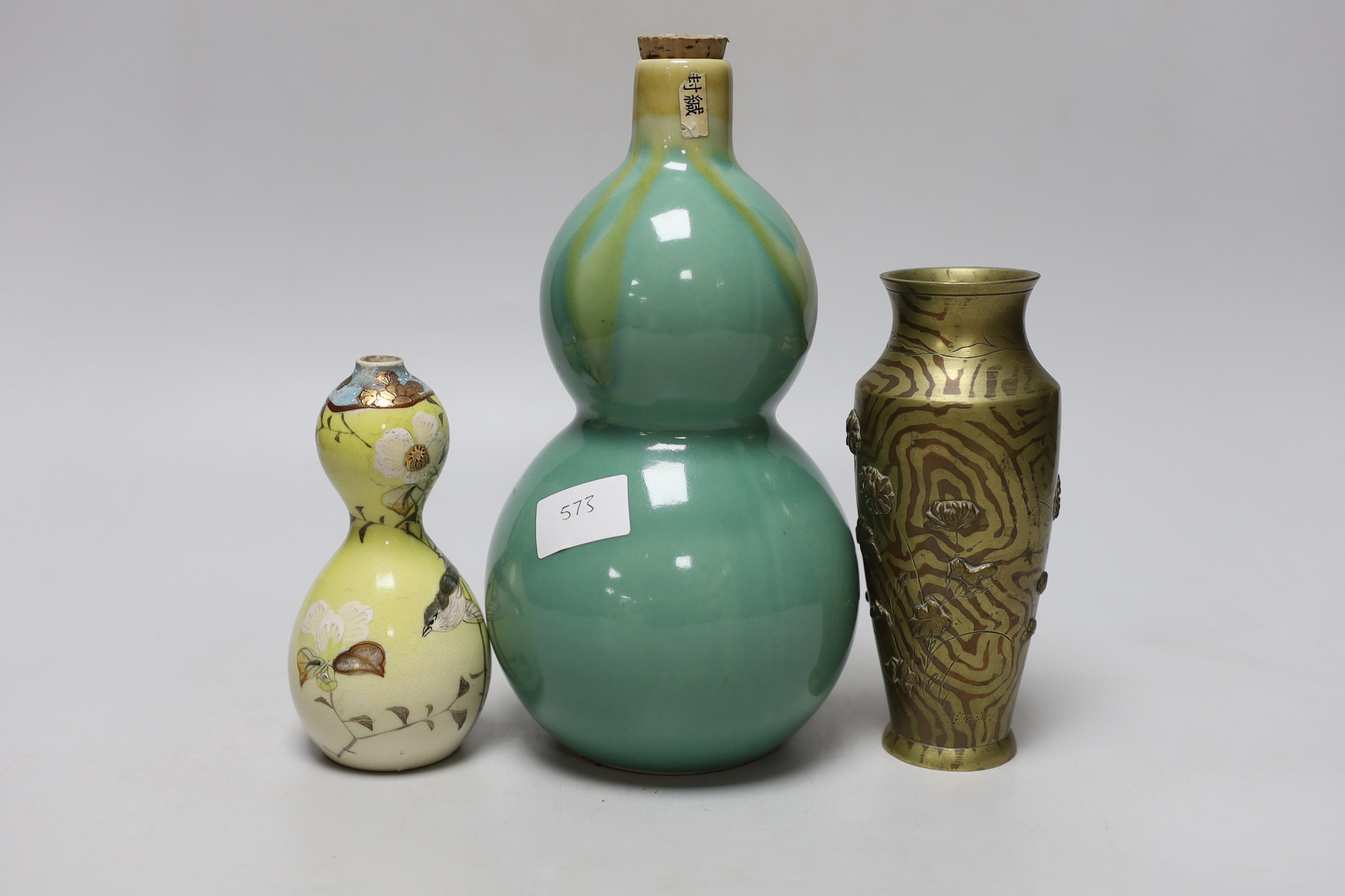 A Japanese bronze faux bois vase, a Satsuma vase and a porcelain tokkuri, a faux bois vase 15cm high (3)